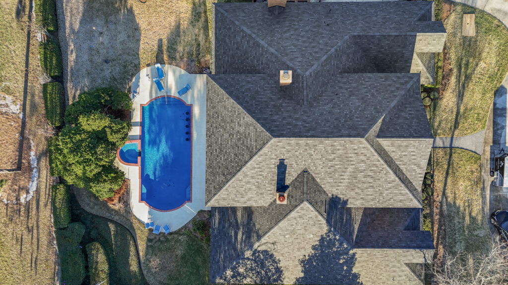 Aerial view of a finished roof replacement job in Jacksonville Florida by Coastal Edge Roofing.